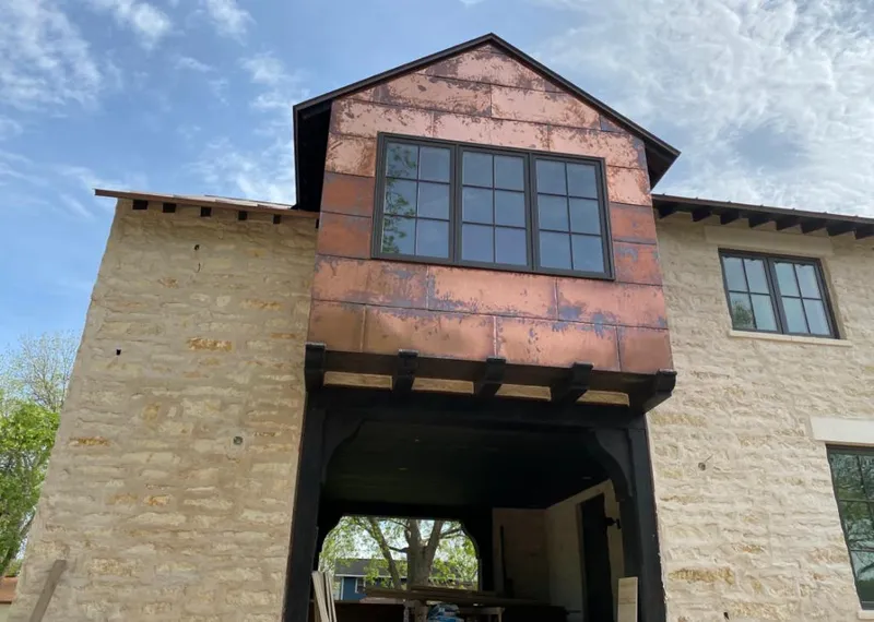 Copper metal panel facade on a stone building for Skylight Installation in Kings Mountain