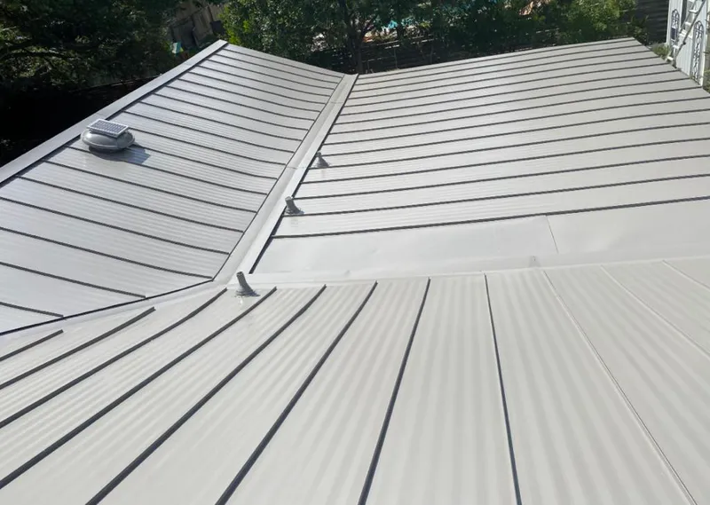 Solar attic fan installed on a metal roof for Roof Ventilation in Kings Mountain